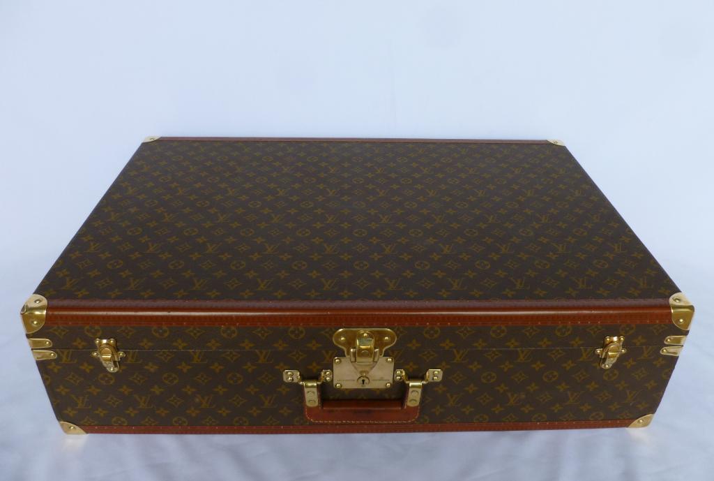 A vintage Louis Vuitton suitcase for sale in an antique shop in